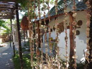 a string of ornaments hanging from a building at Pousada Santa Aldeia in Barra Grande