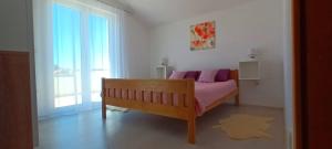a bedroom with a bed and a large window at Leggiero in Benkovac +47 photos