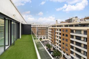 a balcony with green grass on the side of a building at WHome Urban Retreat w/Parking, Elevator & AC by Benfica Stadium in Lisbon