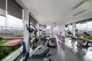 a gym with several treadmills and elliptical machines at WHome Urban Retreat w/Parking, Elevator & AC by Benfica Stadium in Lisbon