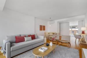 a living room with a couch and a table at WHome Urban Retreat w/Parking, Elevator & AC by Benfica Stadium in Lisbon