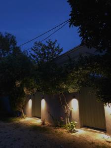 a building with lights on the side of it at night at Anthonas House in Nikiti