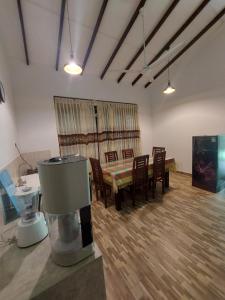 a living room with a table and chairs and a television at Green Stay in Habaraduwa Central