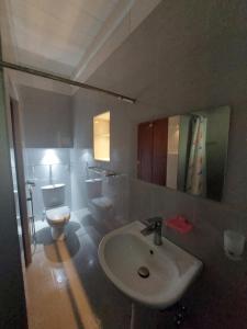 a bathroom with a sink and a toilet at Green Stay in Habaraduwa Central