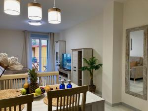 a living room with a table and a dining room at Alborán Costa del Sol in Estepona