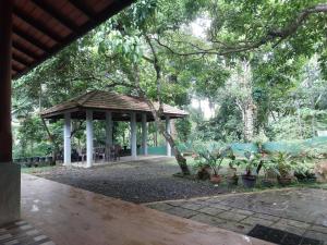 a gazebo in a park with potted plants at Green Stay in Habaraduwa Central