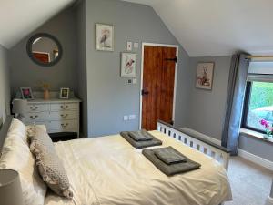 a bedroom with a bed with two towels on it at Huntspill Cottage in Lincolnshire