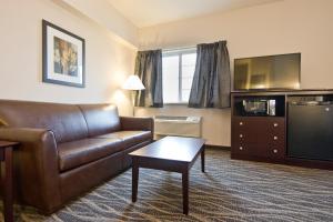 a living room with a couch and a tv at Cobblestone Inn & Suites - Boone in Boone