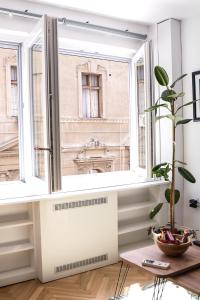 a room with a window with a radiator and a plant at Apartment Petra 073 in Belgrade
