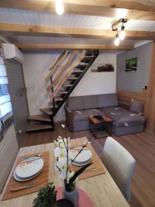 a living room with a couch and a staircase at Cosy Retreat Čatež in Čatež ob Savi