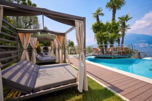 a luxury villa with a pool and a gazebo at Belfiore Park Hotel****S in Brenzone sul Garda