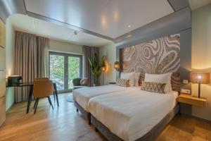 Postel nebo postele na pokoji v ubytování Leonardo Hotel Breda City Center