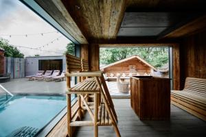 a room with a pool and a wooden house at Ye Olde Bell Hotel & Spa in Retford