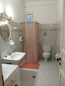 łazienka z umywalką, toaletą i zasłoną prysznicową w obiekcie Wilson & Andrew House - Boho Bliss w mieście (( Sgoúrna ))