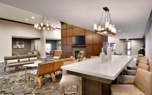 a dining room and living room with a table and chairs at Residence Inn by Marriott Houston I-10 West/Park Row in Houston