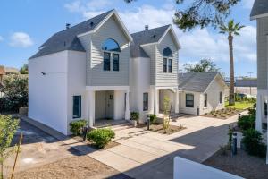 a white house with a gambrel roof at Stylish Phoenix Townhome - Central Location & Sleeps 8 in Phoenix