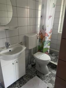 a bathroom with a toilet and a sink at Casa MateiAna in Eforie Nord