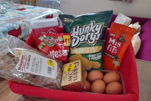 a basket with eggs and other food items in it at Emma's Cottage in Brookeborough
