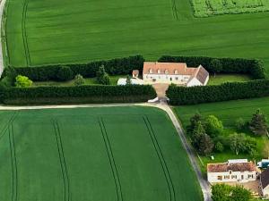 an aerial view of a house in a green field at Bois de Crâne in Landes-le-Gaulois