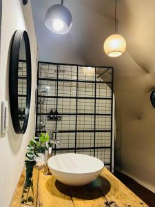 a bathroom with a large white bowl sink on a counter at Don Aniceto Lodges & Glamping in Luján