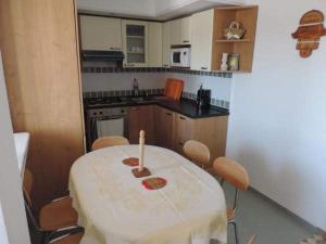 a kitchen with a table and chairs in a room at Appartement de charme in Nabeul