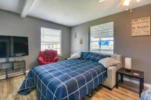 1 dormitorio con 1 cama y TV de pantalla plana en Pet-Friendly Texas Escape with Deck and Fenced-In Yard en Freeport