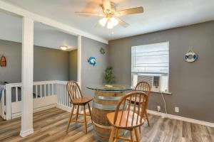 a dining room with a table and chairs and a ceiling fan at Pet-Friendly Texas Escape with Deck and Fenced-In Yard in Freeport