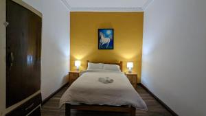a bedroom with a bed with a teddy bear on it at Vibes Aurik in Quito