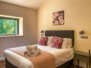 a bedroom with a bed with towels on it at Tranquillity-uk38552 in Endon