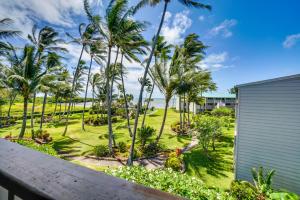 a view from the balcony of a resort with palm trees at Molokai Island Retreat with Ocean View and Pool! in Kaunakakai