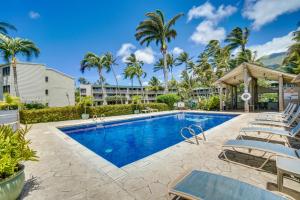 a swimming pool with lounge chairs and a resort at Molokai Island Retreat with Ocean View and Pool! in Kaunakakai