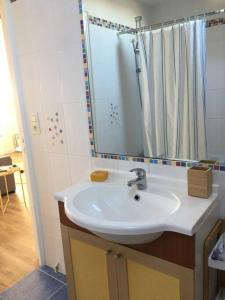a bathroom with a white sink and a shower at Appartement 4 personnes Centre Dinard in Dinard