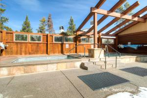 a house with a swimming pool with a wooden fence at Impeccable Ski In Ski Out Unit with Mountain Views from Private Balcony, Steps From Downtown TE402 in Breckenridge