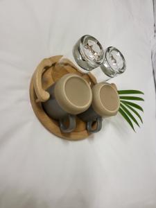 a wooden tray with two glasses and a plant at Generosa of the North in Durban