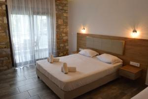 Postel nebo postele na pokoji v ubytování Dioscuri Deluxe Apartments + 20 fotografií