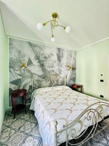 a bedroom with a bed with a painting on the wall at B&B L’Orizzonte Infinito in Chiaromonte