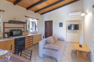 a living room with a couch and a table at Saralen cottage in North Corfu 