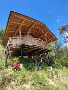 a building with a roof on top of a hill at Casa Kayam Hostal y Residencia Artística in Guatapé