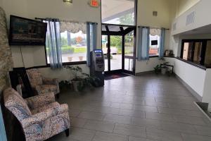 a hallway with two chairs and aoice at Red Roof Inn & Suites Duncan in Duncan