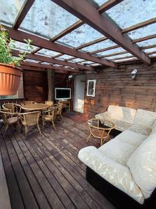 a patio with a couch and a table and chairs at Boszkowo Domki-Stonki in Boszkowo