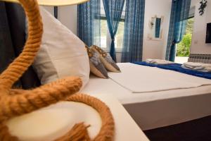 a room with two beds and a sink in it at Villa Kristina Rab in Supetarska Draga