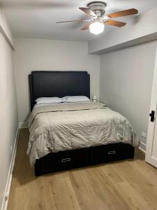 a bedroom with a bed with a ceiling fan at Lincoln Park Aparment with Backyard! in Chicago