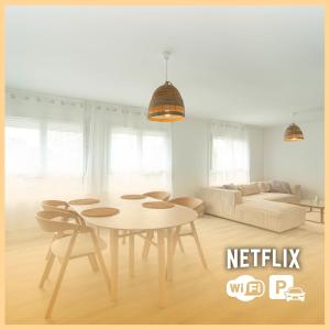 a living room with a table and a couch at La vie en Beige - Appartement à Chalon-sur-Saône in Chalon-sur-Saône