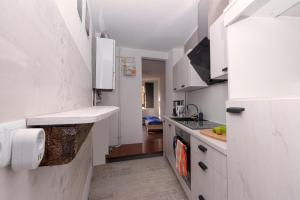 a kitchen with white cabinets and a counter top at Temporary Living - Rest and Relax in Eisenach