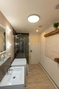 a bathroom with a white sink and a shower at Temporary Living - Rest and Relax in Eisenach