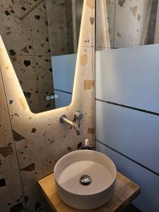 a bathroom with a sink and a mirror at Melidron in Lixouri