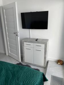 TV a/nebo společenská místnost v ubytování Porta Mare - Dziwnówek - Ferienappartment an der polnischen Ostsee