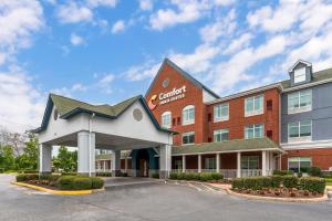 a front view of a hotel with a building at Comfort Inn & Suites Hampton near Coliseum in Hampton
