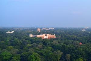 an aerial view of a building in the middle of a forest at Le Meridien New Delhi in New Delhi