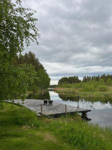 a dock on a river with a body of water at Rantakatti Apartments in Punkaharju